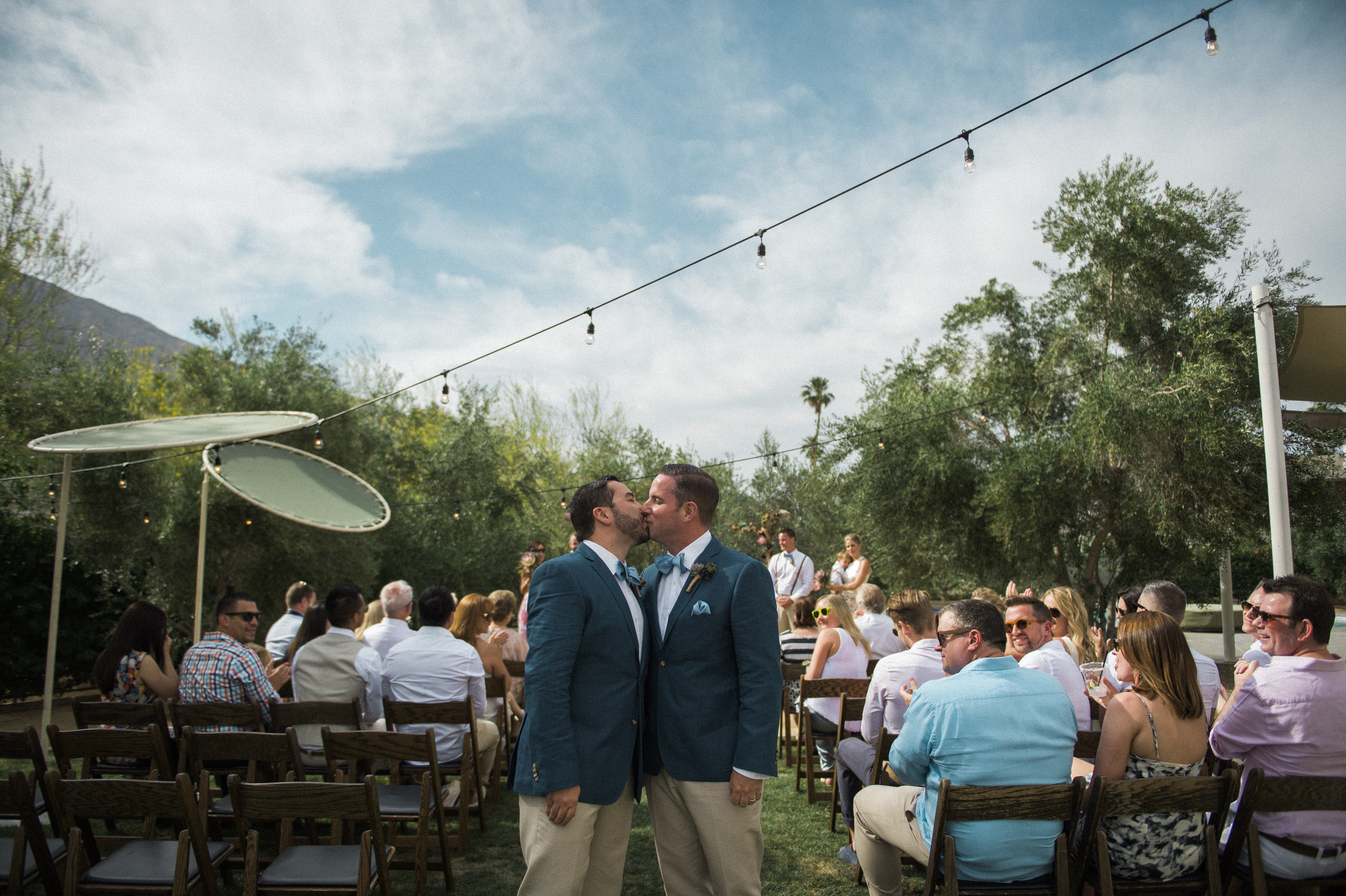 grooms kissing after ceremony at Ace Hotel in Palm Springs