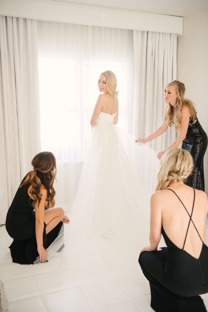 Bride being attended to by her bridesmaids