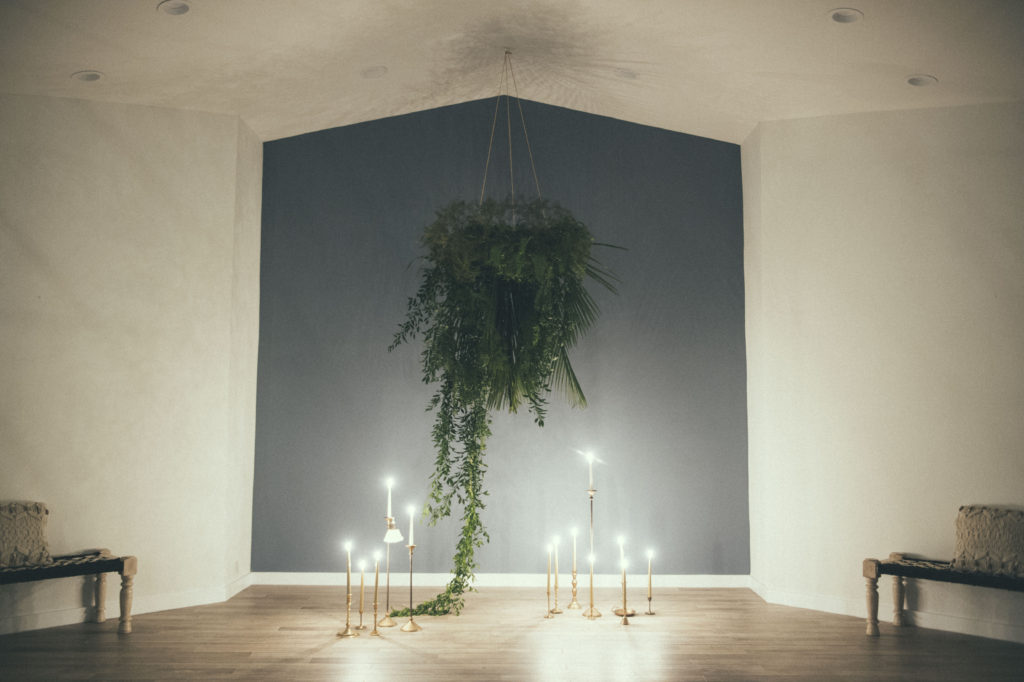 ceremony altar with hanging ferns an candlelight