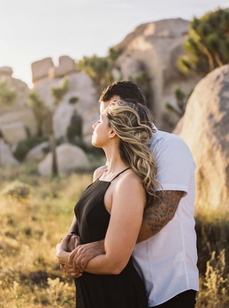 bride and groom in an embrace for their joshua tree engagement