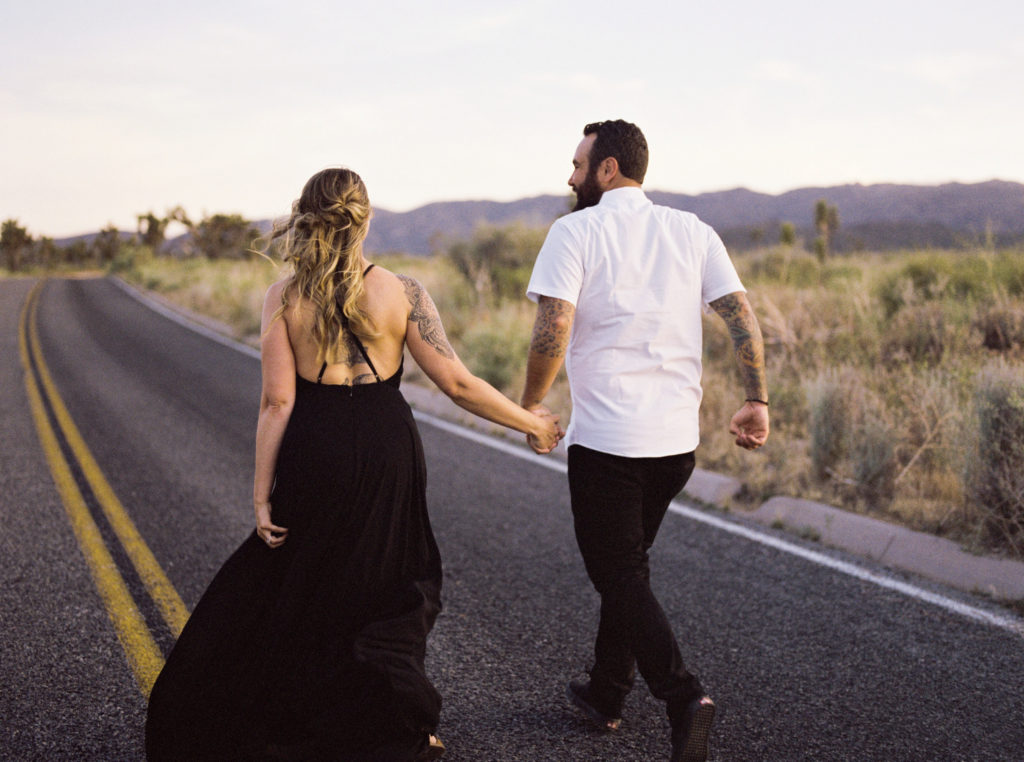 running down the street for bride and groom joshua tree engagement 