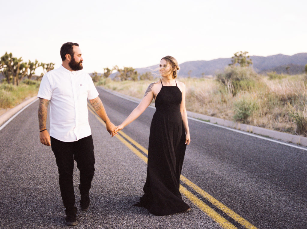 Joshua Tree engagement photo shot in film of two people holding hands