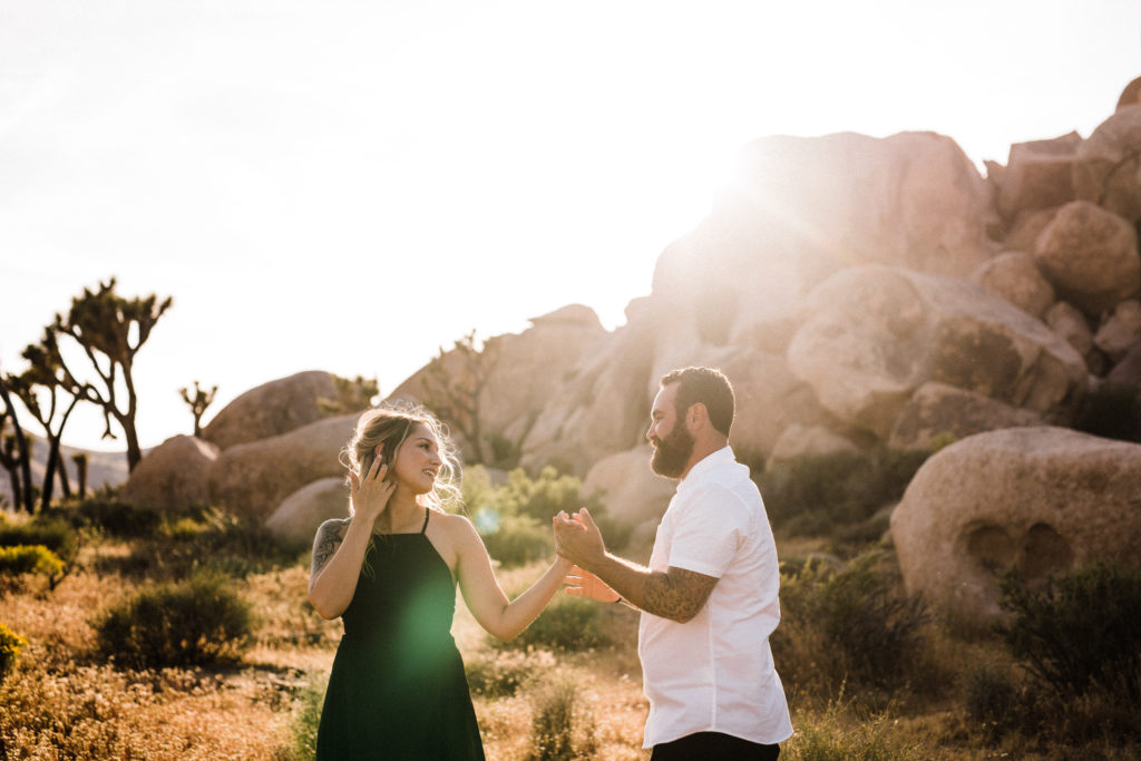 Engaged couple holding hands for their Joshua Tree engagement