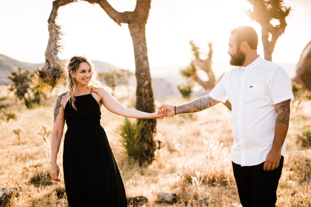 bride and groom holding hands for their joshua tree engagement