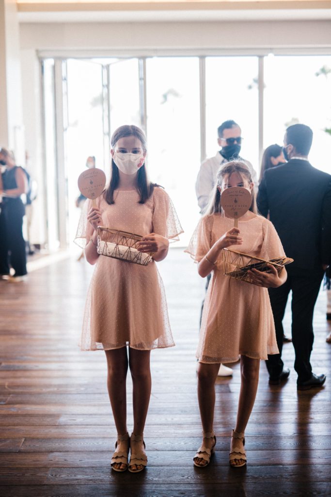 Flower girls wearing masks for a micro wedding in California. 