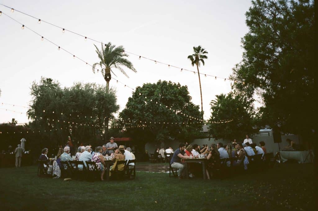 guests seated at their tables for reception on grassy lawn
